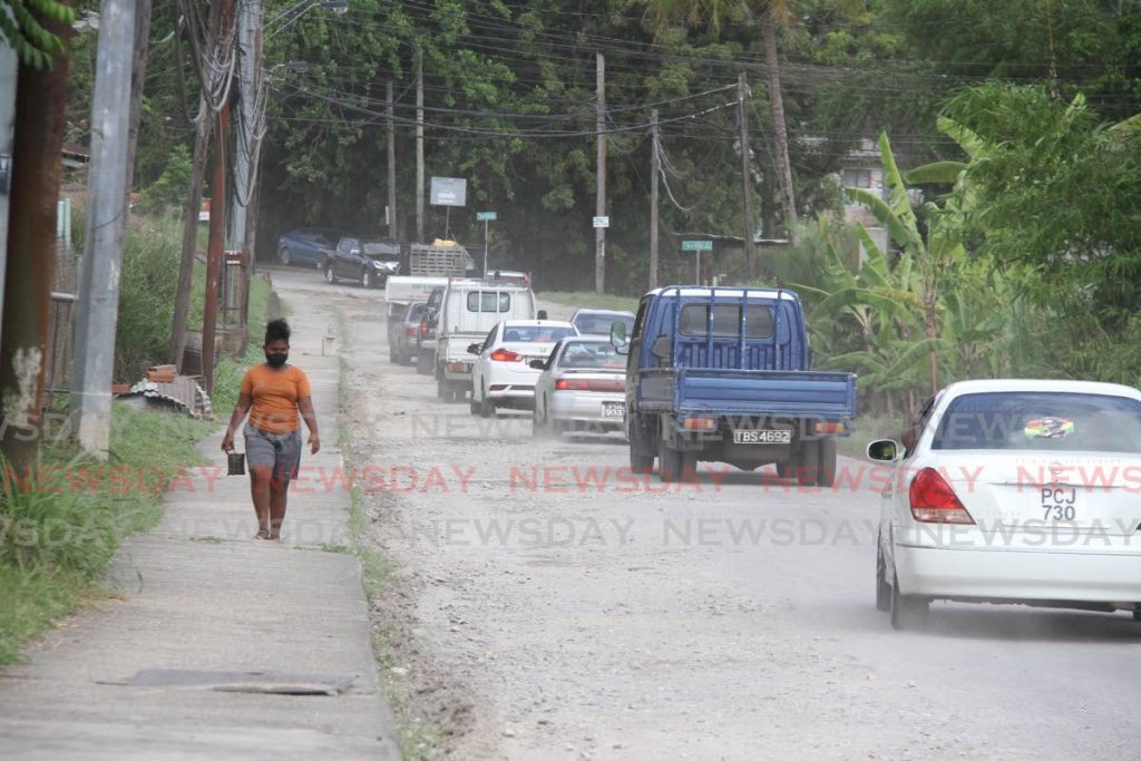 A resident walks along the Guapo/Cap-de-Ville Main Road, Port Fortin on July 13. WASA on Friday announced it had replaced a faulty line on the road. File photo/Angelo Marcelle 