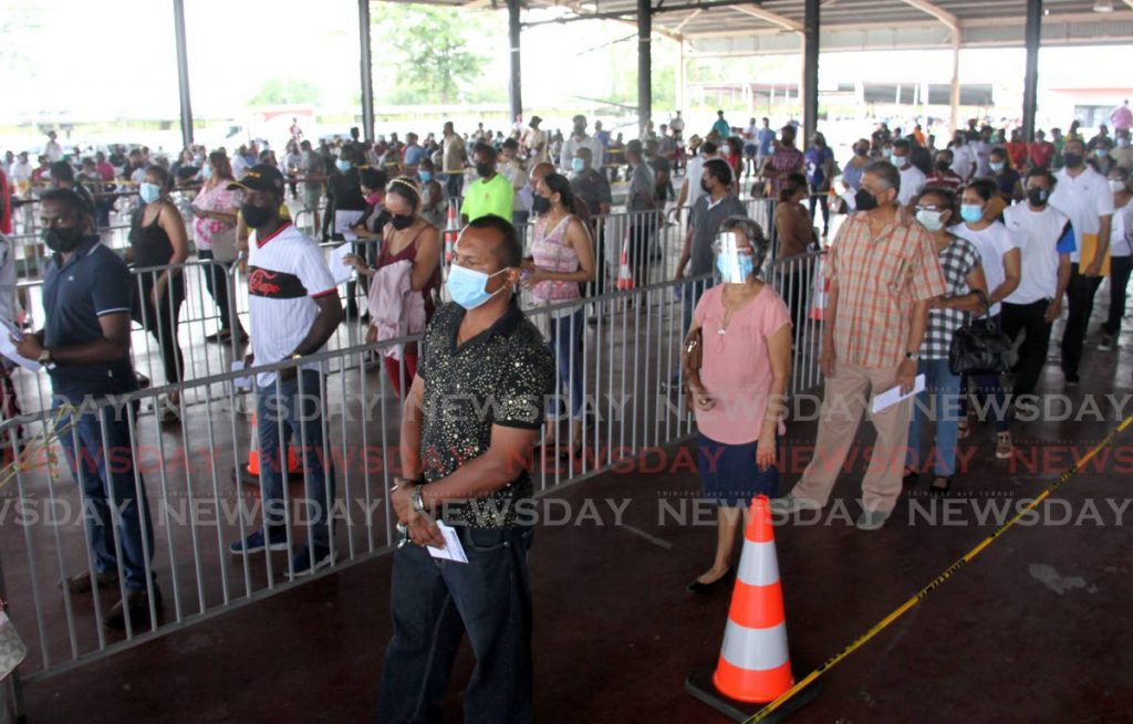 In this file photo, members of the manufacturing sector wait in line to receive their second dose of the Sinopharm vaccine at the Divali Nagar Site in Chaguanas. - Photo by Ayanna Kinsale
