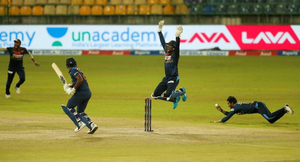 India's Ruturaj Gaikwad (second from left) looks back after being dismissed as Sri Lankan players celebrate during the third Twenty20 International between Sri Lanka and India in Colombo, Sri Lanka, on Thursday. (AP PHOTO) - 