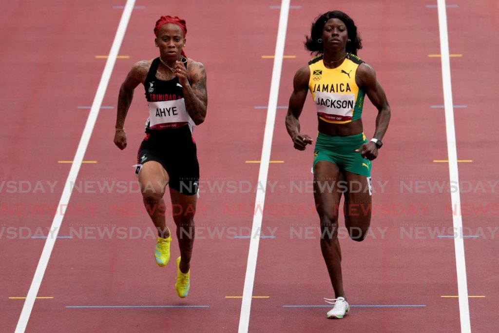 Michelle-Lee Ahye, left, wins her heat in the women's 100-metre run in Tokyo. AP PHOTO - AP