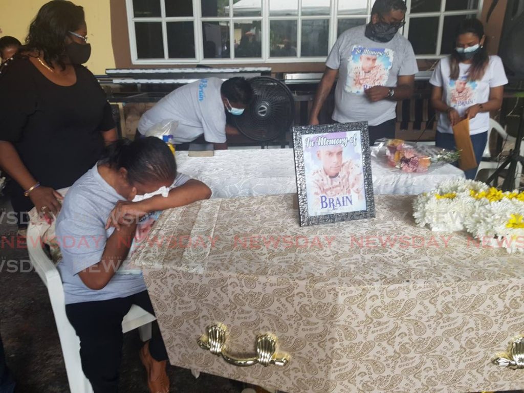 Mary Boodoo weeps for her murdered son Parasram Rennie “Brain” Boodoo during his funeral in Freeport on Saturday. - Photo by Yvonne Webb