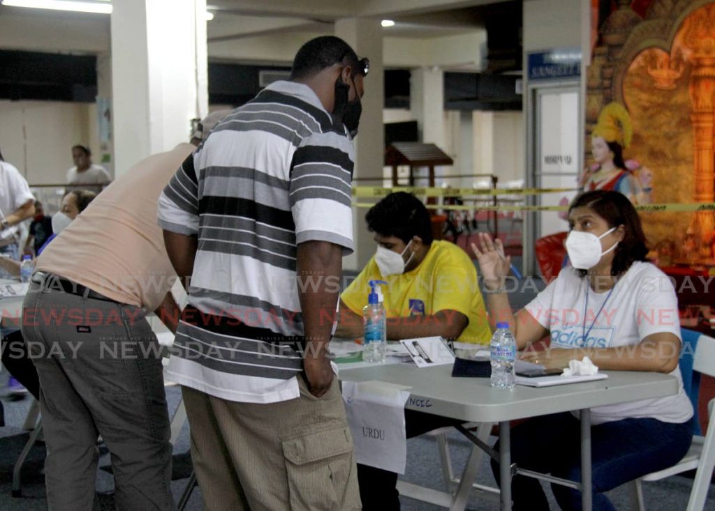 Citizens register before receiving the covid19 vaccine at the Divali Nagar site in Chaguanas. - Photo by Ayanna Kinsale 
