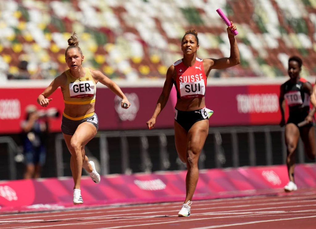 Gina Luckenkemper, of Germany (left), leads Salome Kora, of Switzerland in a semifinal of the women's 4x100-metre relay at the 2020 Summer Olympics, on Thursday, in Tokyo, Japan. TT's Kelly-Ann Baptiste is at right (AP PHOTO) - 
