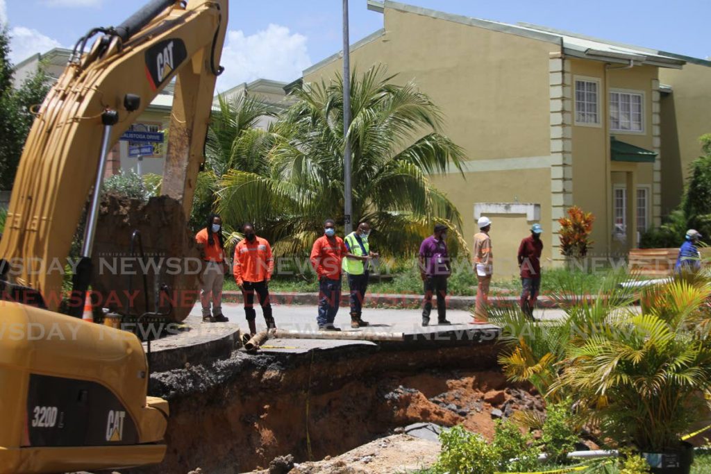 Officials of HDC, T&TEC and WASA was on site for repair works of a sewer pipe at Oasis Greens, Chagaunas on Friday afternoon. - Photo by Marvin Hamilton