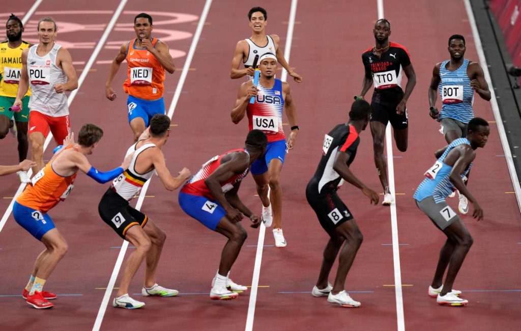 Michael Norman (centre), prepares to hand the baton to Bryce Deadmon on their way to the gold medal in the final of the men's 4x400-metre relay at the 2020 Summer Olympics, on Saturday, in Tokyo, Japan. Second from right, Dwight St Hillaire awaits the baton from his TT teammate Jereem Richards. (AP PHOTO) - 