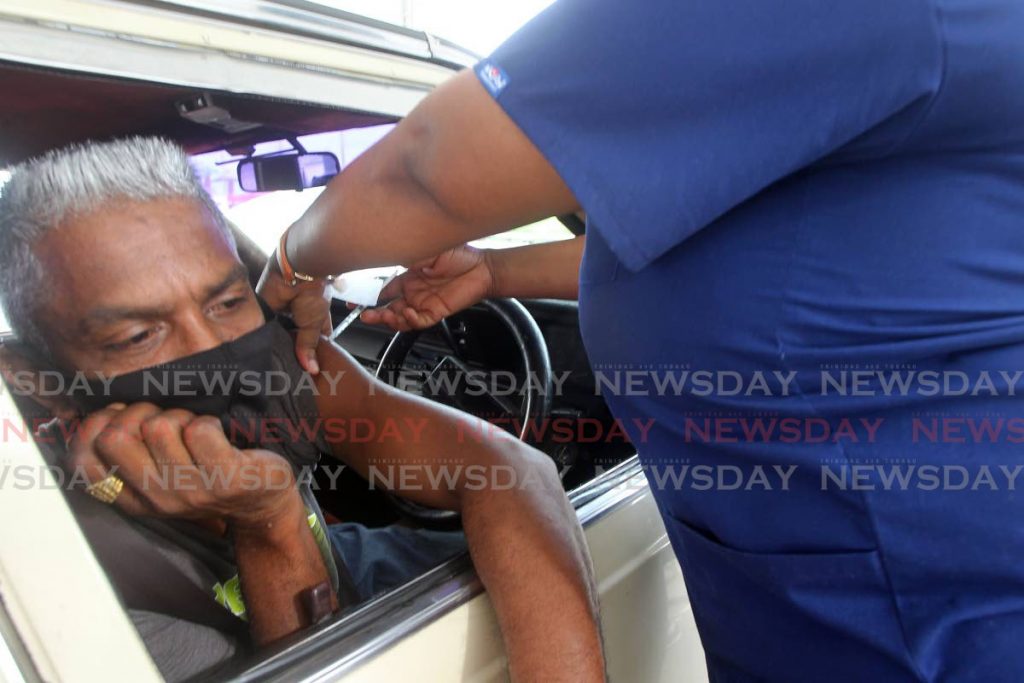 Anand Mahabir of La Romaine gets a vaccine jab. Photo by Lincoln Holder - Lincoln Holder