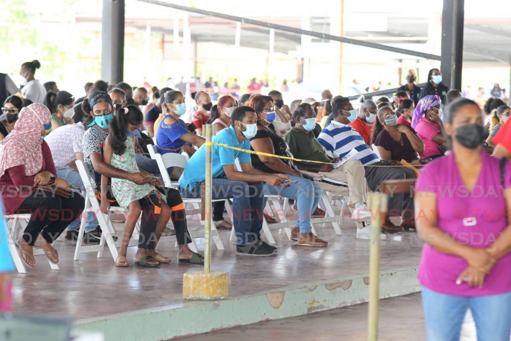 In this August 17 file photo people wait to receive their second dose of the Sinopharm vaccine at the Divali Nagar, Chaguanas. Photo by Lincoln Holder
