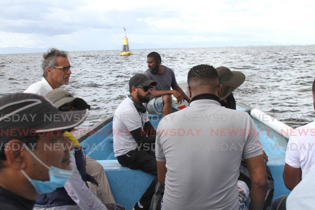 In this file photo, Fishermen and Friends of the Sea secretary Gary Aboud, left, and a media team on the Gulf of Paria. - 