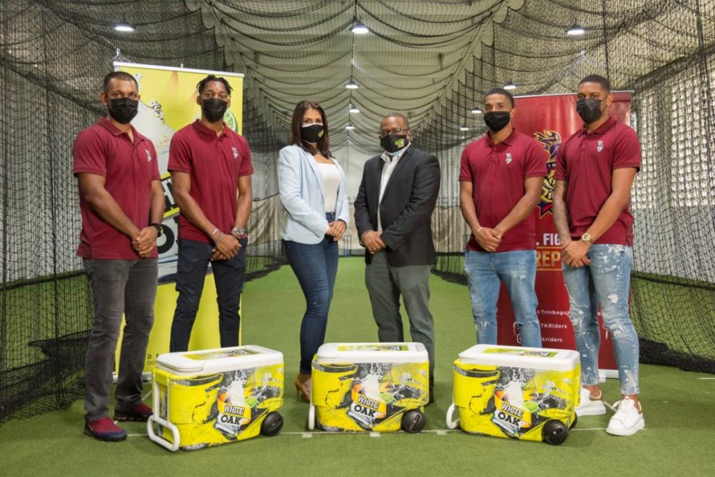 TKR players Denesh Ramdin (left), Khary Pierre (second from left), Leonardo Julien (second from right) and Tion Webster (right) along with Hema Ramkissoon, executive manager-marketing, Angostura (third from left) and Angostura's acting CEO Ian Forbes, , at the Queen's Park Oval indoor nets following the official announcement of White Oak as the designated official rum sponsor of the Trinbago Knight Riders (TKR). Photo courtesy Angostura Limited 