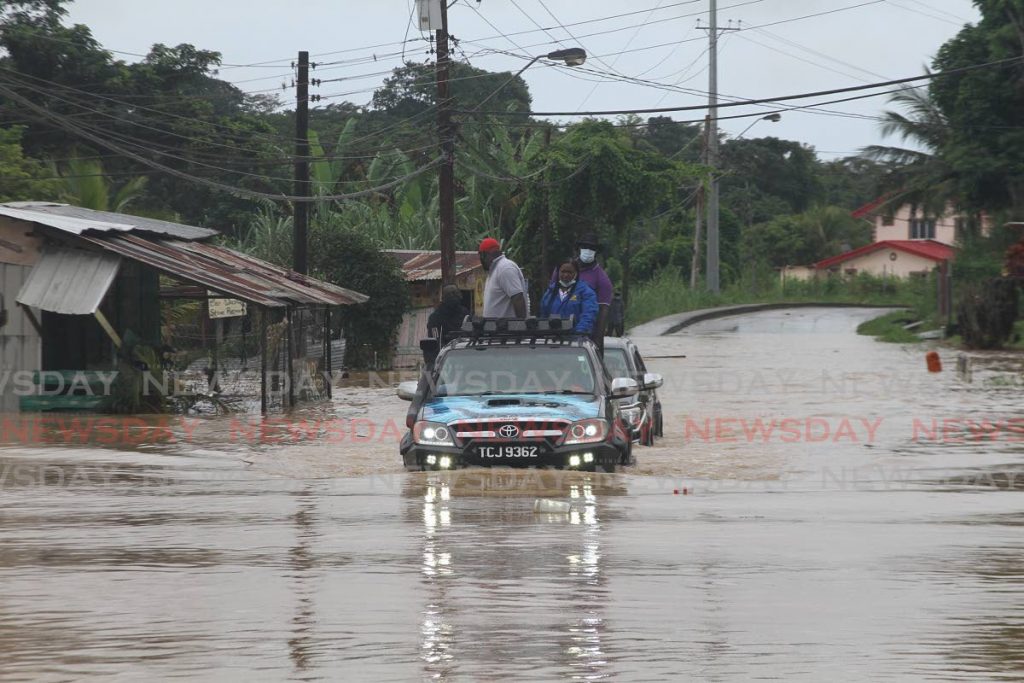Point Fortin MP Kennedy Richards Jr takes a drive through flood waters in Ranch Quemado after heavy rain left the community marooned on Sunday. - Marvin Hamilton