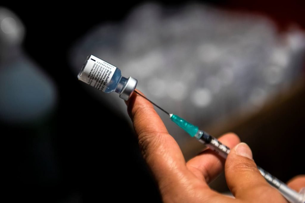 A nurse prepares a shot of the Pfizer vaccine. 