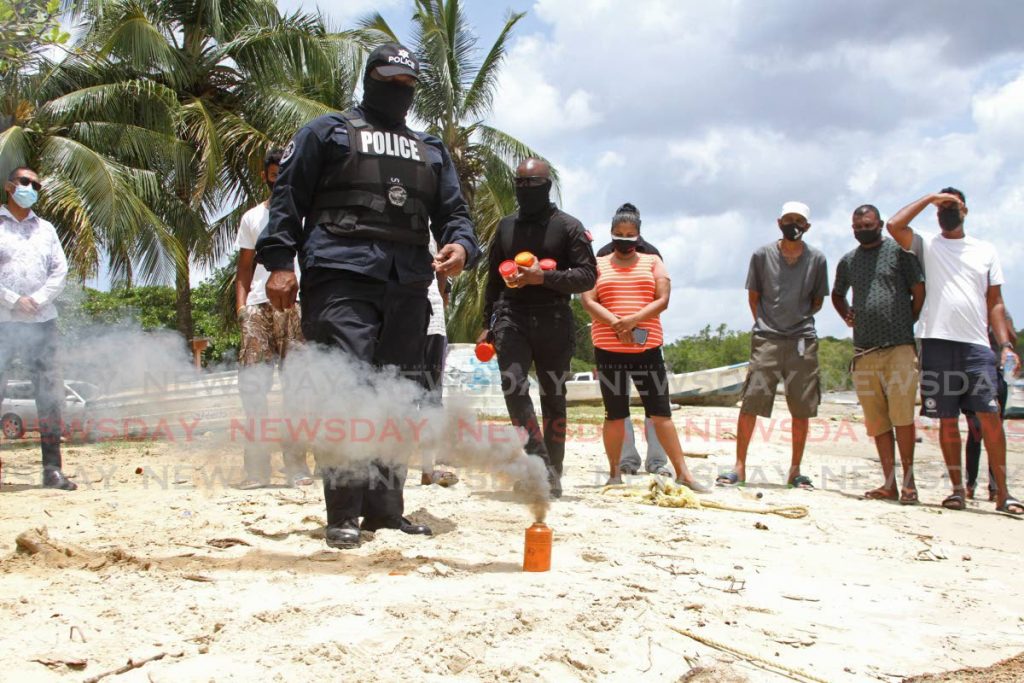 Sgt Temper demonstrates how to use a flare. Photo by Marvin Hamilton