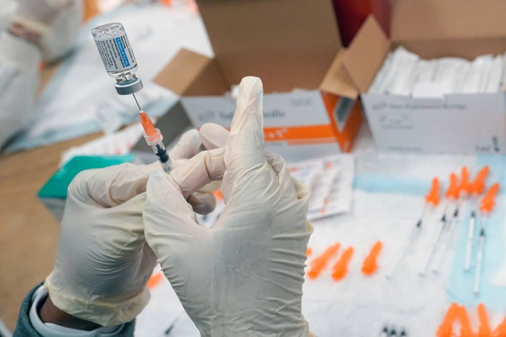 A registered nurse fills a syringe with the Johnson & Johnson covid19 vaccine. AP photo.
