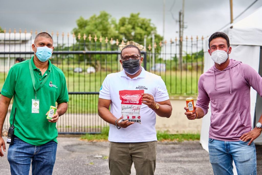 Angostura’s CEO (Ag) Ian Forbes, centre, with president of the Couva Point Lisas Chamber of Commerce, Mukesh Ramsingh, left, and president of the Chaguanas Chamber of Commerce, Richie Sookhai at the Chambers’ vaccination drive held at Camden, Couva, on Ausut 15.  Photo courtesy Angostura. 