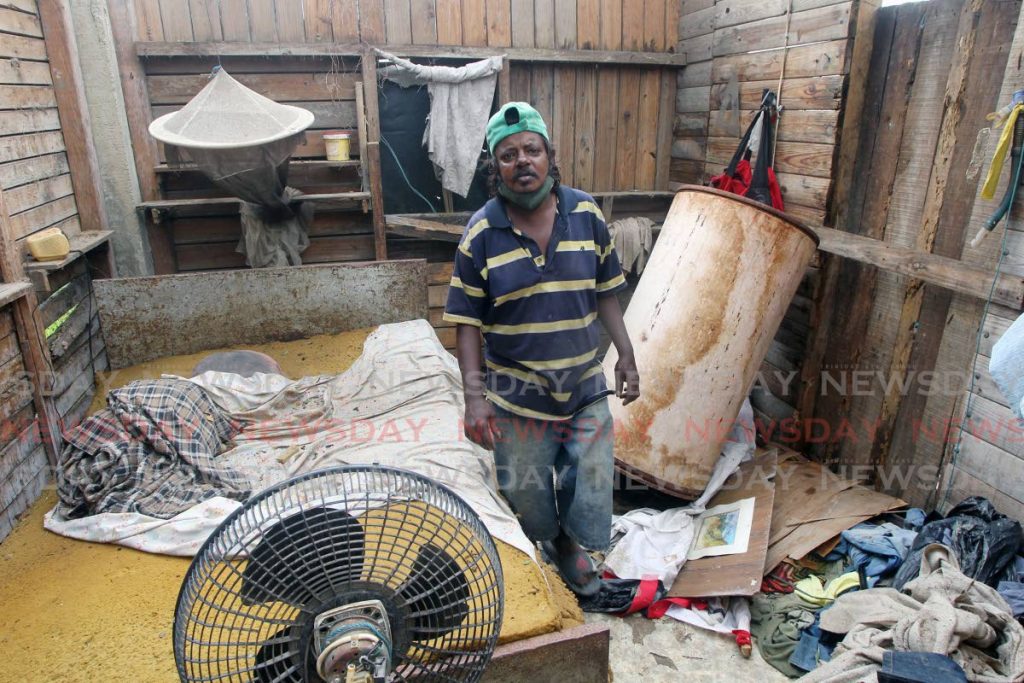 Los Iros resident Narmanie Seenathsingh stands in the bedroom of what was his home. Photo by Lincoln Holder