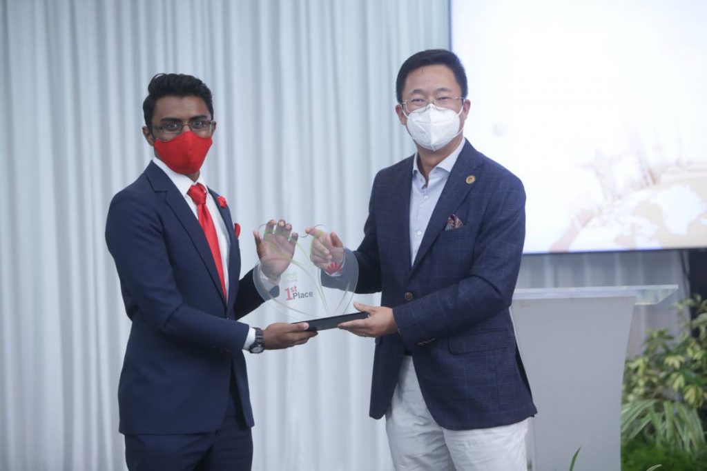 Top TT Seeds for the Future 2020 student, Brandon Mohammed, receives an award from Huawei TT CEO, Jeff Jin. Photo courtesy Huawei - 