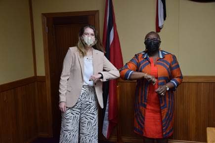 British High Commission Harriet Cross, left, and Minister of Planning and Development Camille Robinson-Regis, touch elbows during a recent meeting to discuss UK-TT relations.  - 