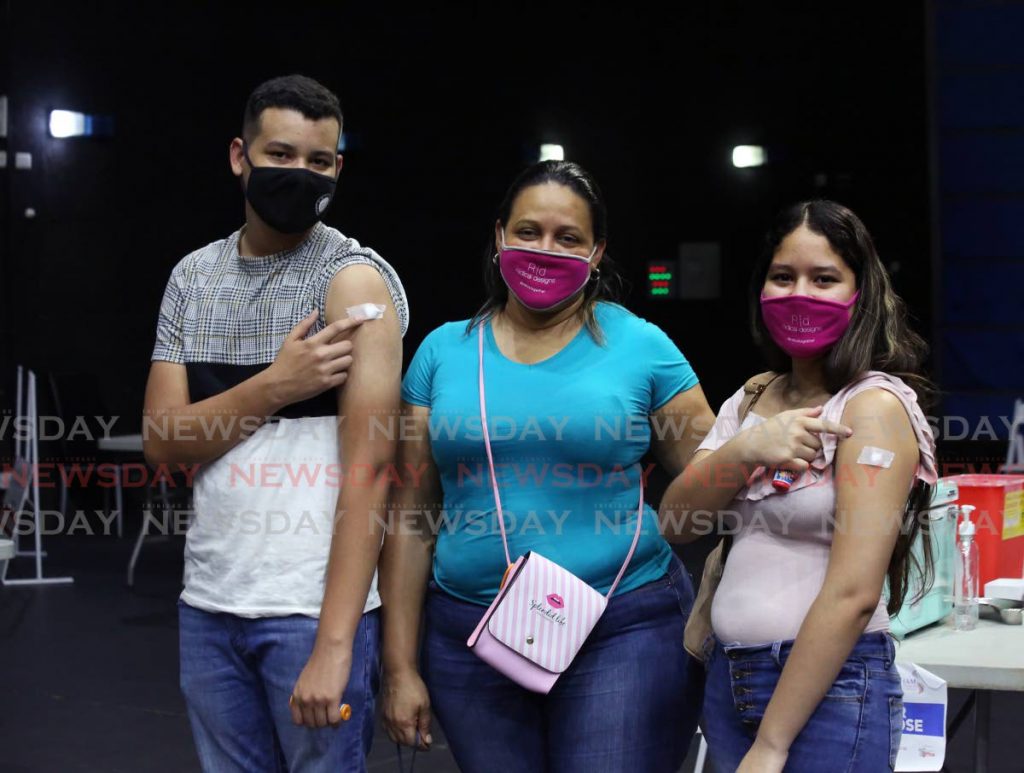 Venezuelan Luz Pinango, centre, and her children Jose Ruiz, left, and Angela Ruiz who received the Pfizer covid19 vaccine at the National Academy for the Performing Arts in Port of Spain on Saturday.  - Photo by Sureash Cholai