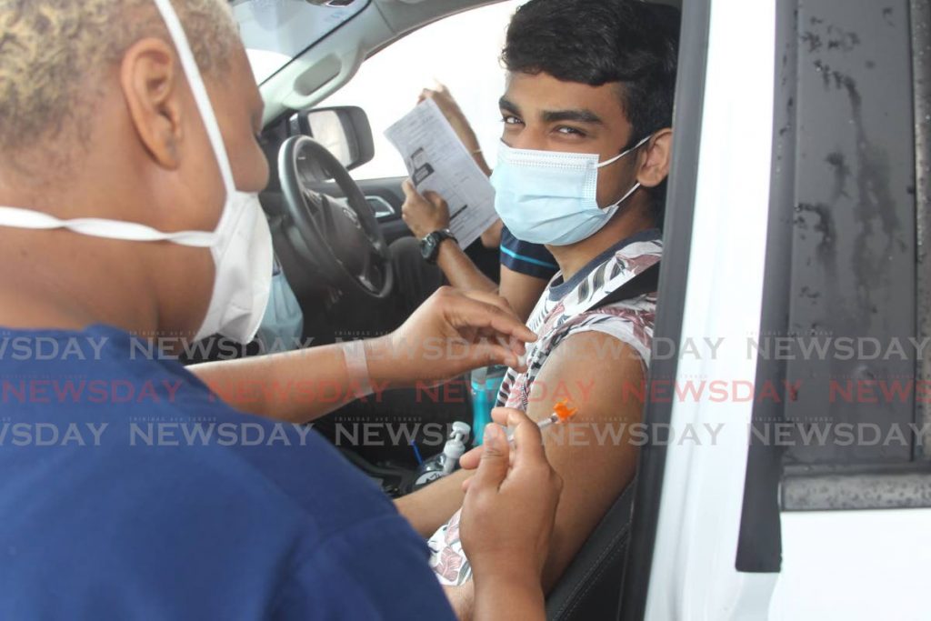 Stefan Katwaroo, 15, of Naparima College received his first jab of the Pfizer covid19 vaccine at the Proman vaccine site at the Ato Boldon stadium. - Lincoln Holder