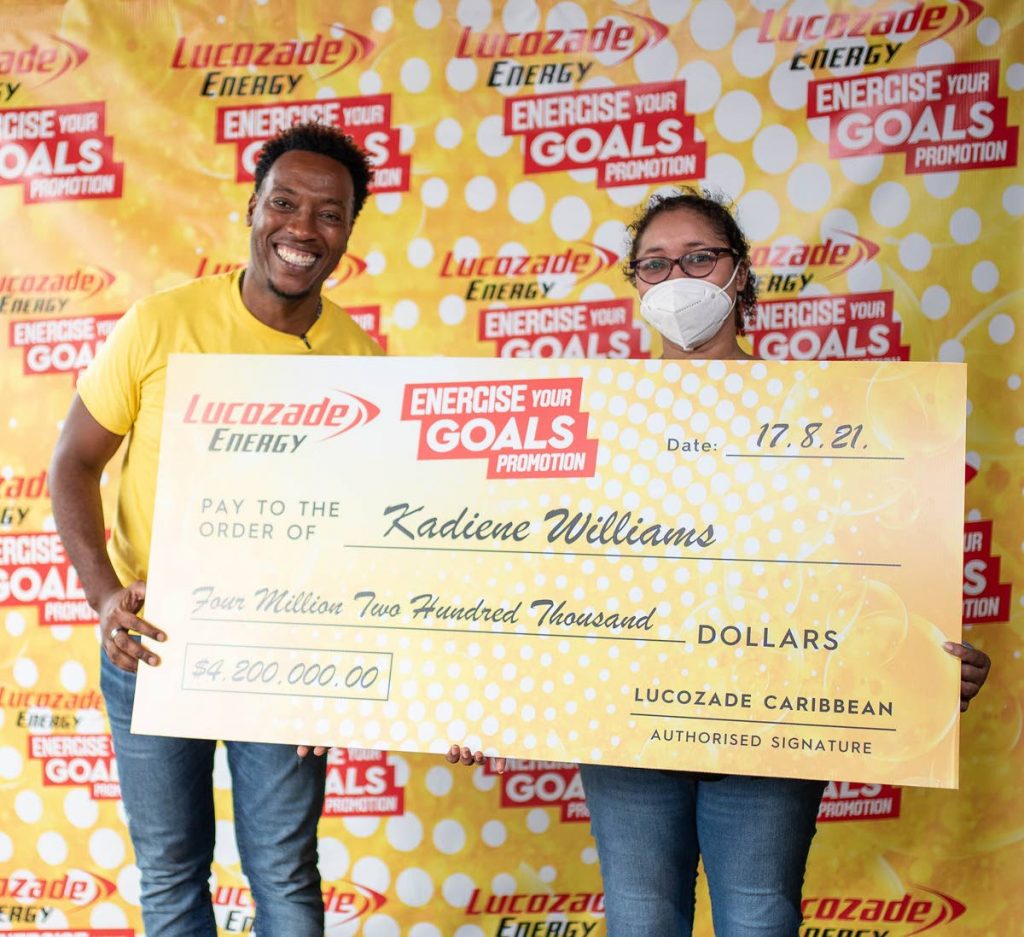 Lucozade Energise Your Goals finale host Dufton Shepherd stands with grand prize winner, Kadeine Williams.  - 