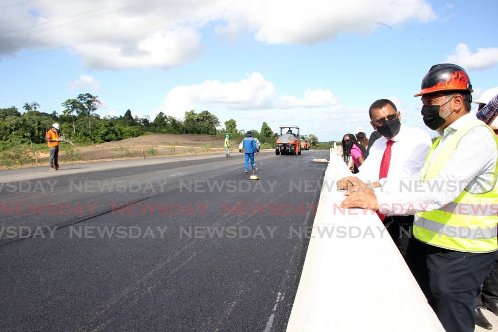 In this file photo the Minister of Works and Transport Rohan Sinanan speaks with Namalco Construction Services CEO Naeem Ali as work continued along the Solomon Hochoy Highway extension in Parrylands. - 
 Photo by Lincoln Holder