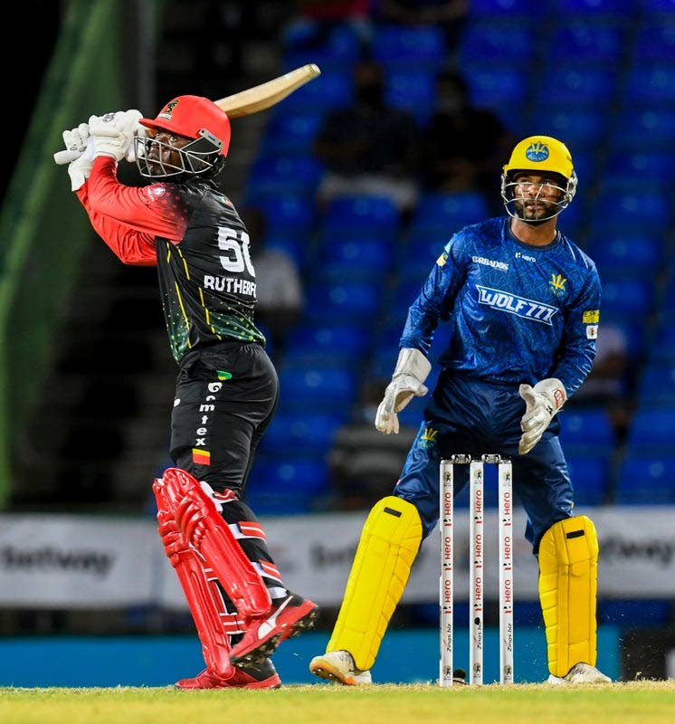 Sherfane Rutherford (left) of St Kitts/Nevis Patriots hits a six as Barbados Royals wicketkeeper Shai Hope watches during the 2021 Hero Caribbean Premier League match 2 between Barbados Royals and St Kitts/Nevis Patriots at Warner Park Sporting Complex on Thursday in Basseterre, St Kitts. (Photo by CPL T20/Getty Images) - 