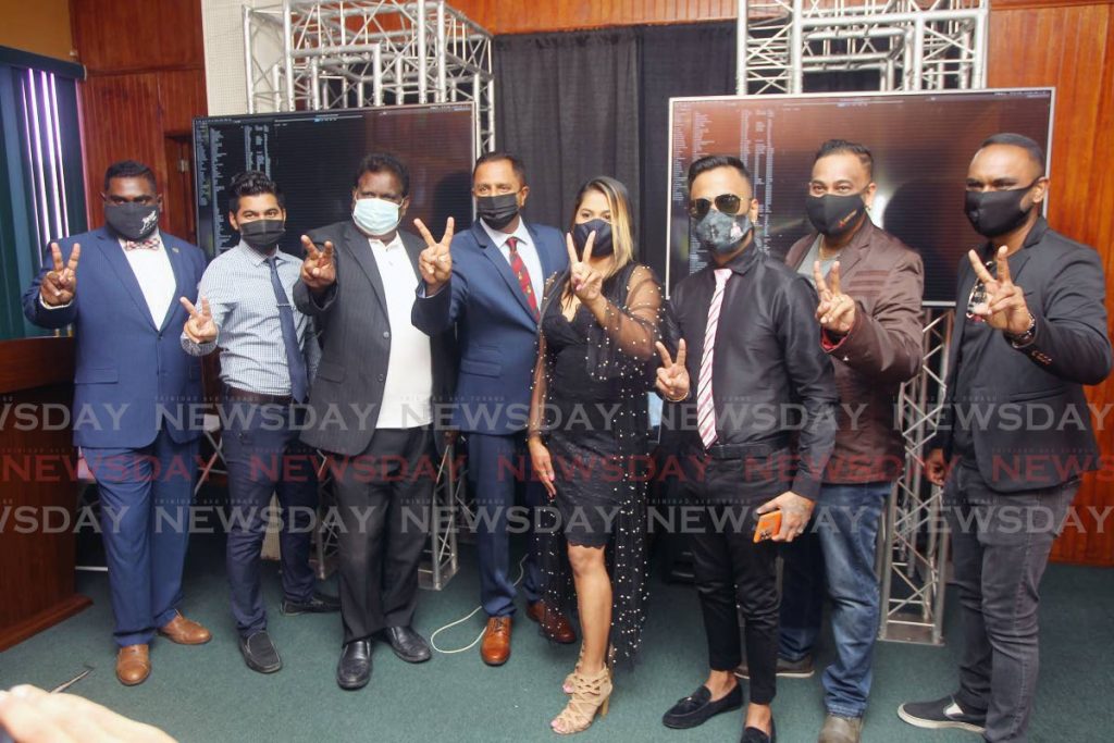 Southex CEO George Singh and several chutney soca artistes who contributed to the Let's Get Vaccinated campaign at the Southex office on Independence Avenue, San Fernando. - Photo by Lincoln Holder