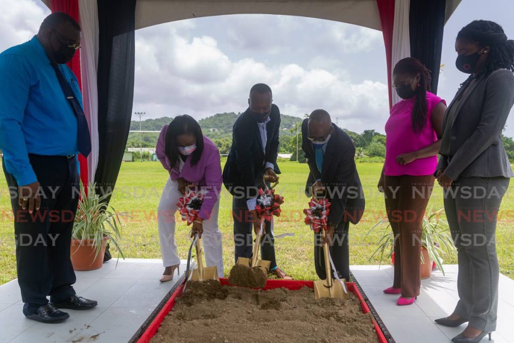 Chief Secretary Ancil Dennis, centre, Secretary of Sport Tracy Davidson-Celestine, left, and Wilfred Des Vignes of the Goodwood Village Council turn the sod for the construction of the Goodwood pavilion at the Goodwood Recreation Ground on Thursday.  - David Reid