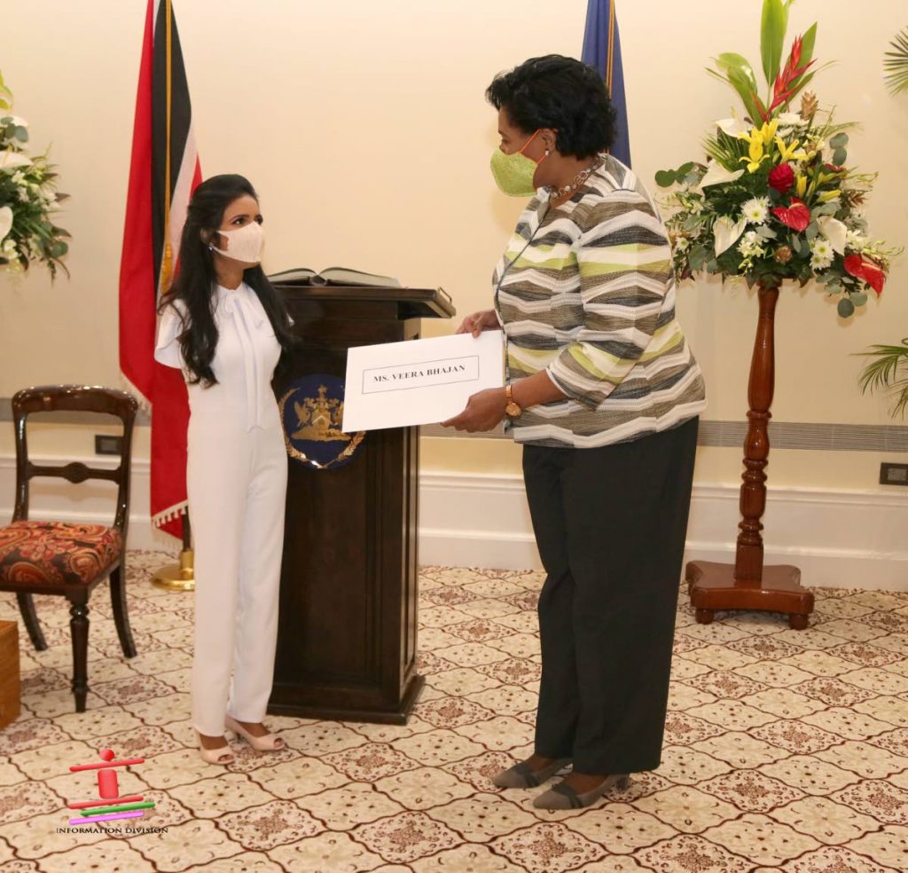 President Paula-Mae Weekes presents Veera Bhajan with her appointment letter as a lay assessor to the Equal Opportunities Tribunal on March 17, 2021. Photo courtesy Office of the President. - 