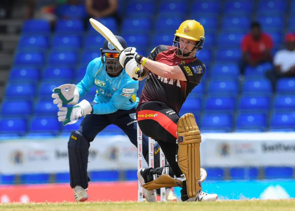 Trinbago Knight Riders batsman Colin Munro sweeps a ball for a boundary while St Lucia Kings wicketkeeper Andre Fletcher watches during the 2021 Hero Caribbean Premier League match 7 between St Lucia Kings and Trinbago Knight Riders at Warner Park Sporting Complex on Sunday in Basseterre, St Kitts. (Photo by CPL T20/Getty Images) - 