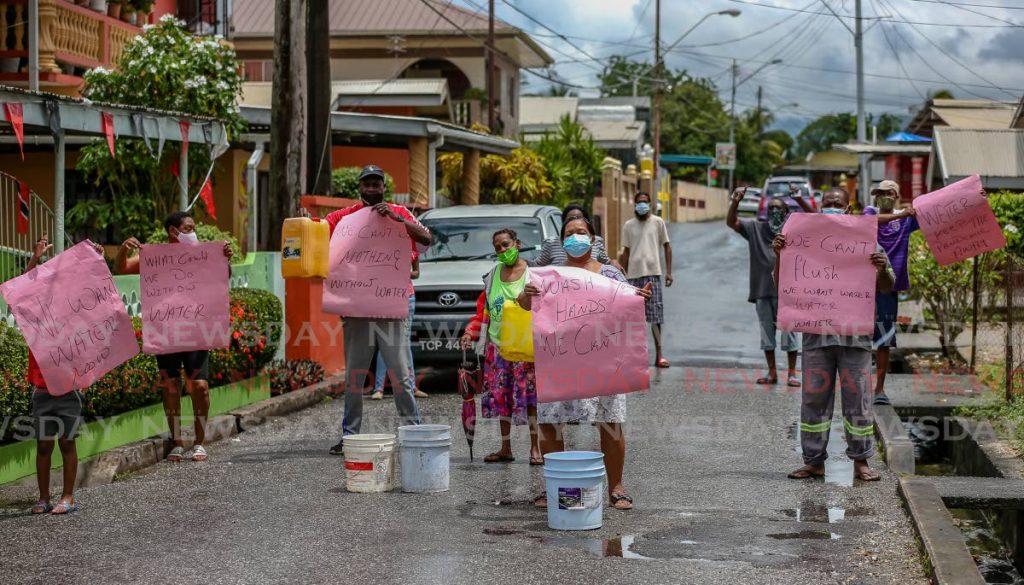 Residents of Peytonville, Carapo protest on Independence Day to highlight their frustration over the lack of a regular water supply. - Jeff Mayers