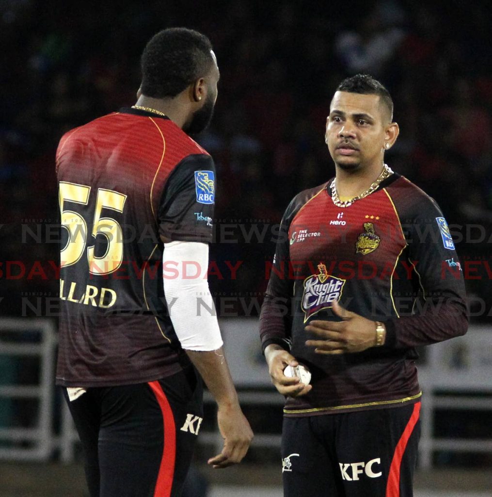In this file photo, TKR off spinner Sunil Narine, right, talks with his captain Kieron Pollard. TKR lost the opening match of the 2021 Hero CPL against Guyana Amazon Warriors , on Thursday, at Warner Park cricket grounds, St Kitts.  - ROGER JACOB