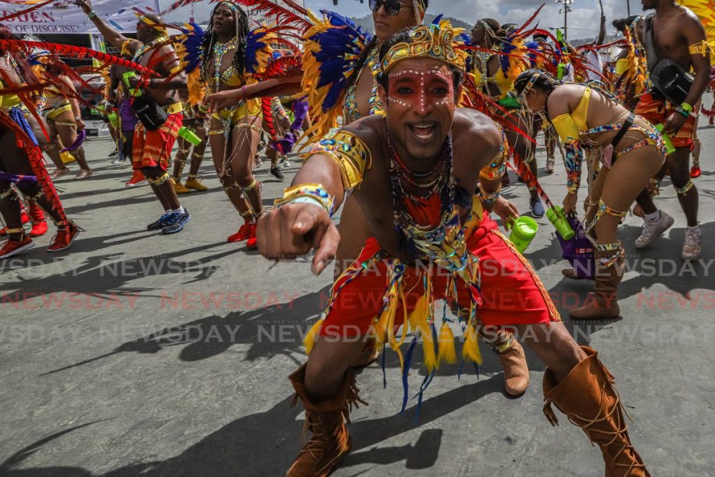 On Carnival Tuesday in 2020 these Paparazzi mas band revellers portray Hidden-Masters of Disguise at the Queen's Park Savannah, Port of Spain. - JEFF K MAYERS