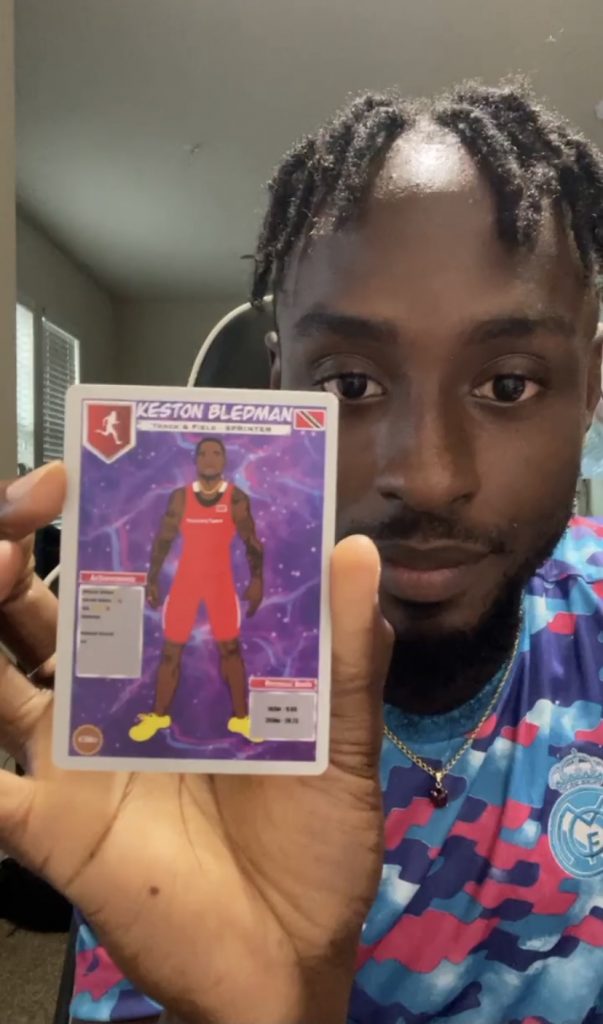 Trinidad and Tobago sprinter Jereem Richards holds one of his athletics trading cards. 