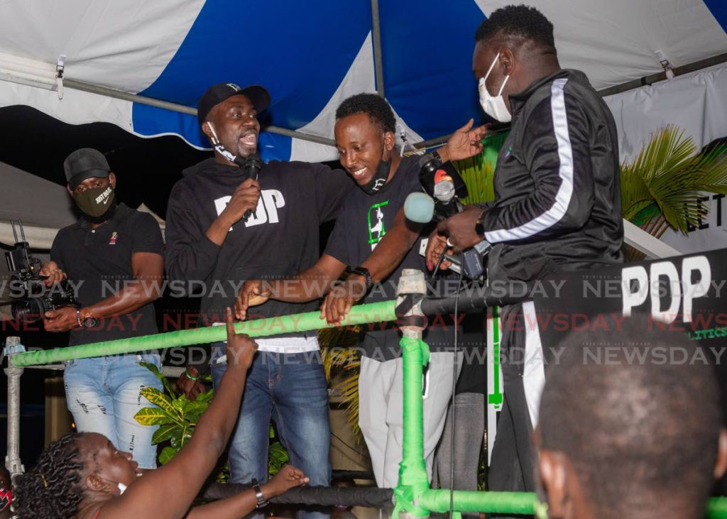 FILE PHOTO: PDP deputy leader Farley Augustine, second from left, and PDP political leader Watson Duke, right, ask supporters in Roxborough to show love to defeated Canaan/Bon Accord candidate Joel Sampson on election night. - 