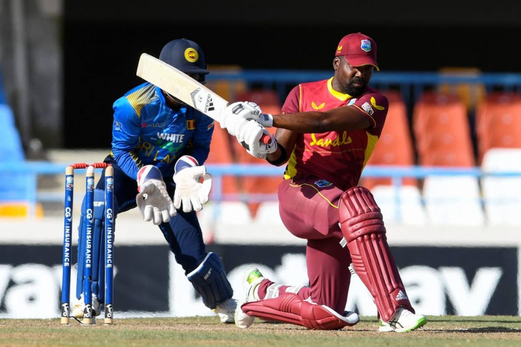 In this March 14, 2021 file photo, West Indies batsman Darren Bravo sweeps the ball for a boundary during the 3rd One-Day International against Sri Lanka at the Sir Vivian Richards Cricket Stadium in North Sound, Antigua. West Indies won the game by five wickets.  - 