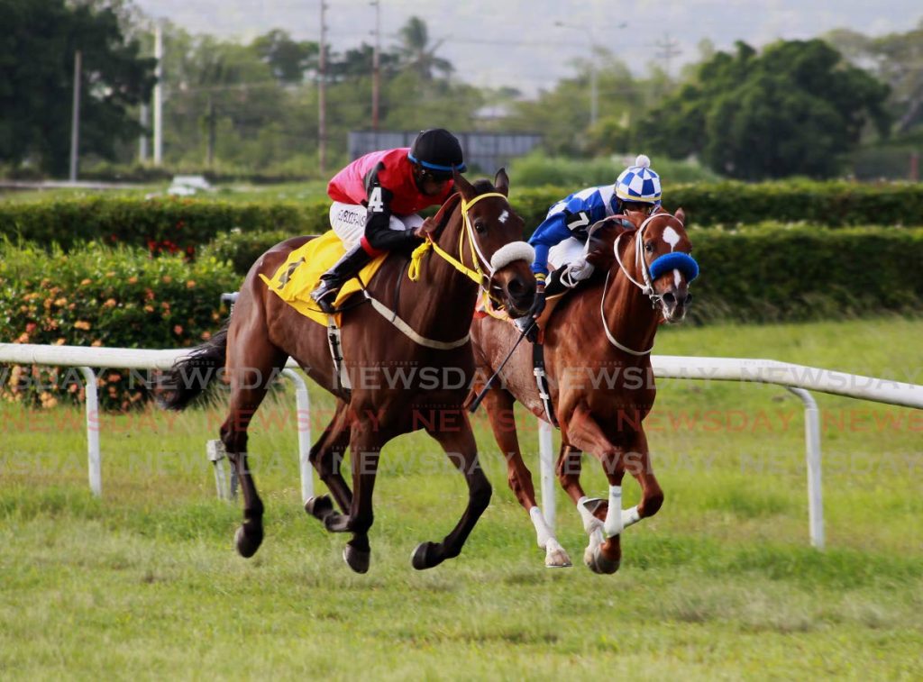In this March 27 file photo, Bella Riva (left), ridden by Brian 
Boodramsinghh, overtakes favourite General JN, ridden by Dillon Khelawan, to win the NFM Champagne Stakes at the Santa Rosa Park, Arima. - ROGER JACOB
