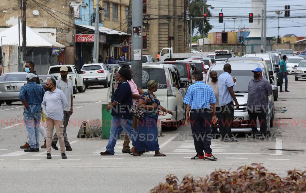 Pedestrians and taxi drivers on the Port of Spain to Chaguanas taxi stand, Broadway, Port of Spain.  File photo/Sureash Cholai