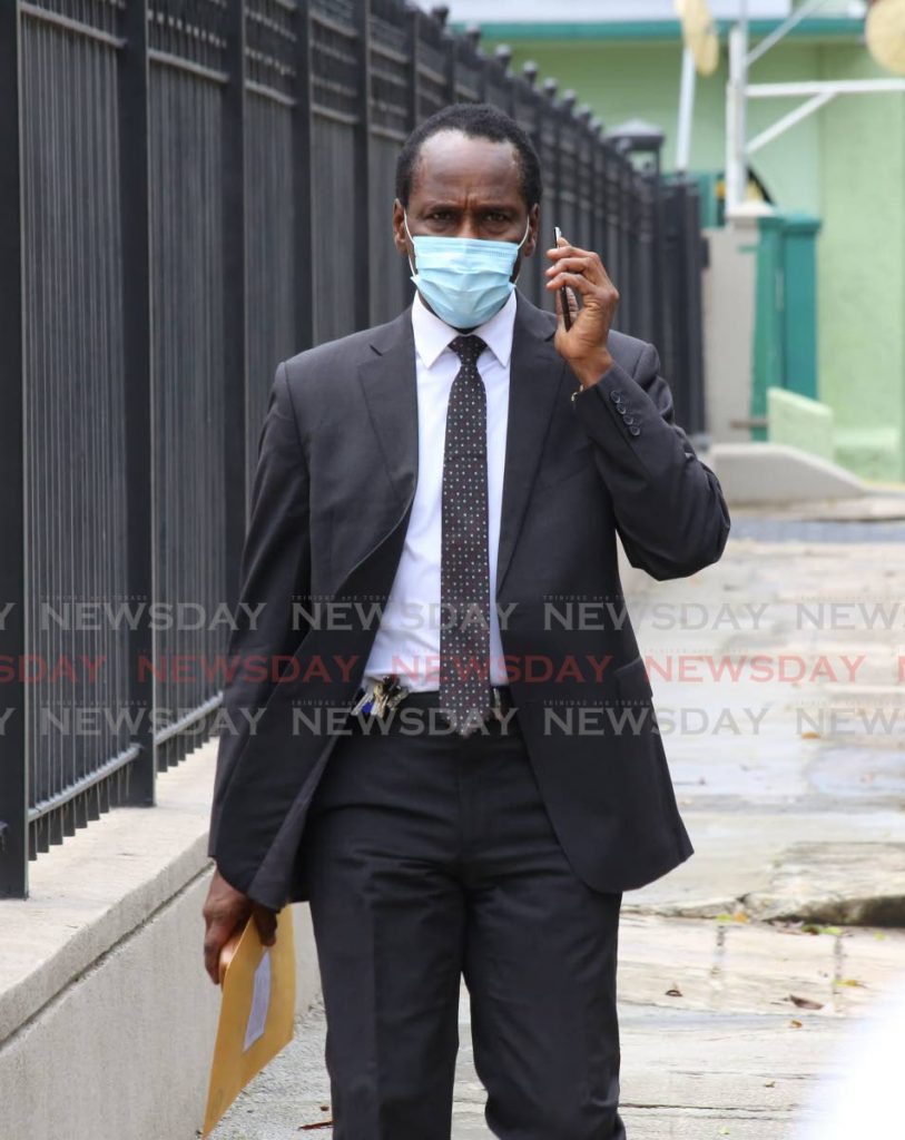 National Security Minister Fitzgerald Hinds on his way to Parliament on Friday.  - Photo by Sureash Cholai