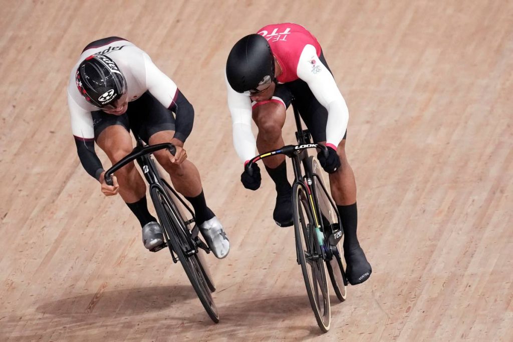 Nicholas Paul of Team Trinidad And Tobago, right, competes in the track cycling men's omnium scratch race at the 2020 Summer Olympics in Japan. AP Photo - 