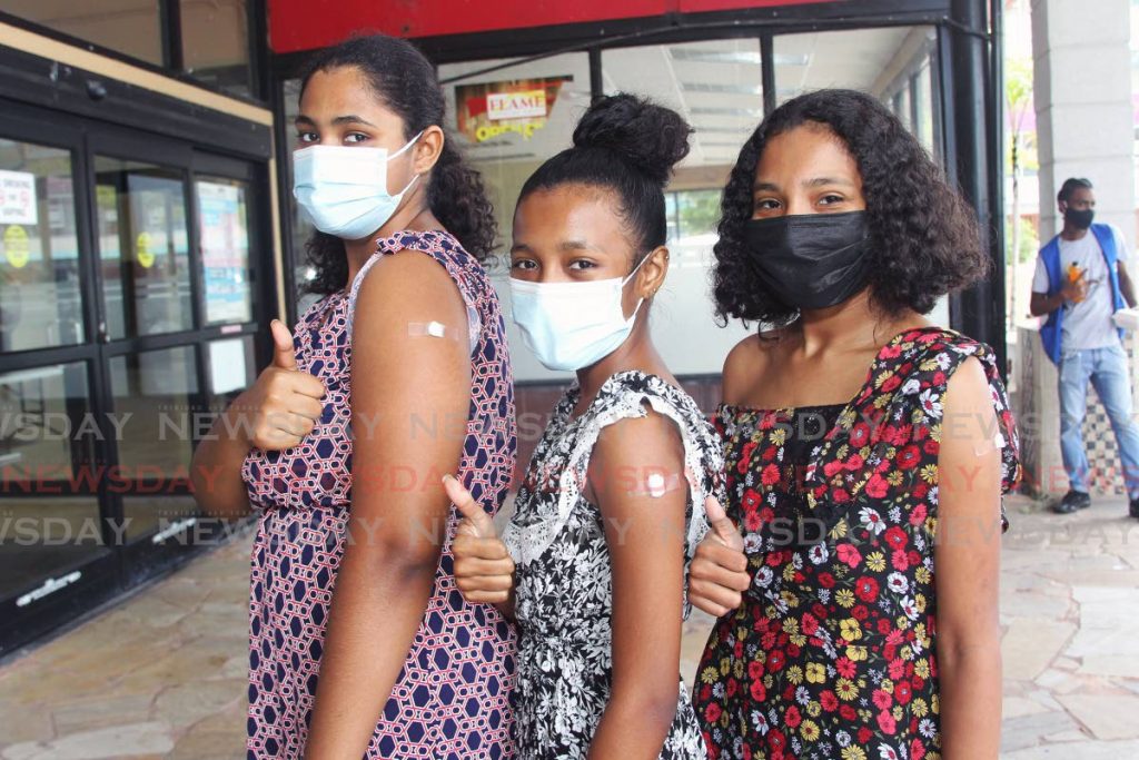 Teenagers Shenisa Gunpat, Nathalia Jones and Isabella Jones got the Pfizer vaccine at Centre Pointe Mall, Chaguanas on August 21. The vaccination of secondary students is a condition for the return of face-to-face classes for students in forms four to six. - FILE PHOTO/LINCOLN HOLDER