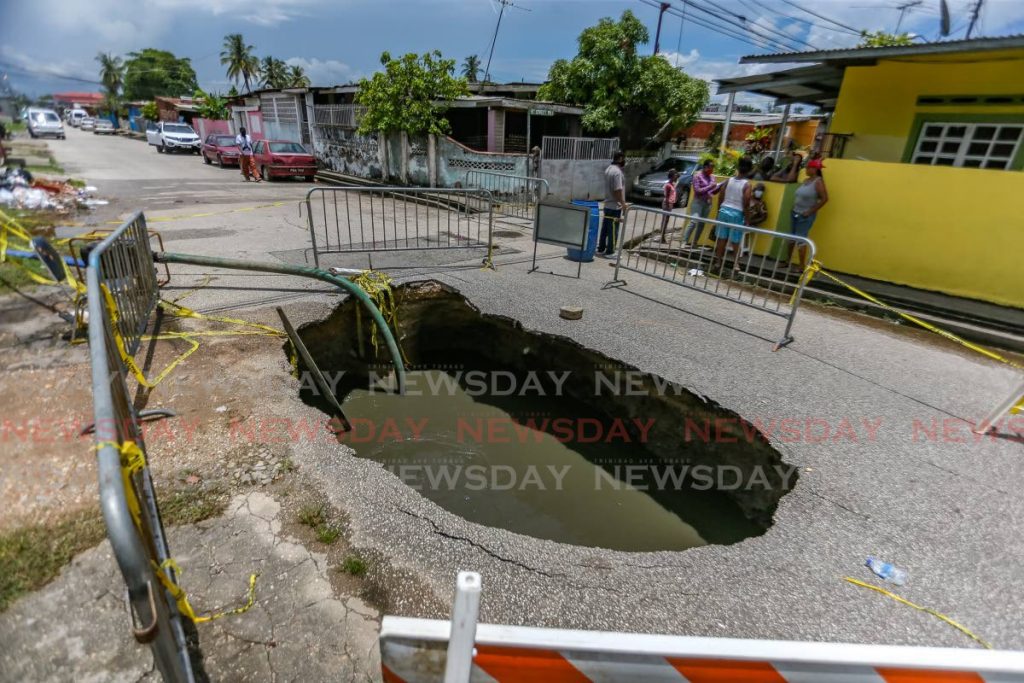 CAUSING A STINK: The large sinkhole which was caused by a ruptured sewer line at Main Street, Beetham Gardens has been a source of frustration for residents for the past three weeks.     - Jeff Mayers