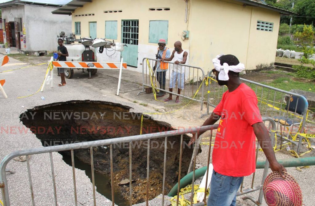 Ronald Douglas calls on WASA to start repairs on the sinkhole at Main Street, Beetham Gardens on Wednesday. - Ayanna Kinsale