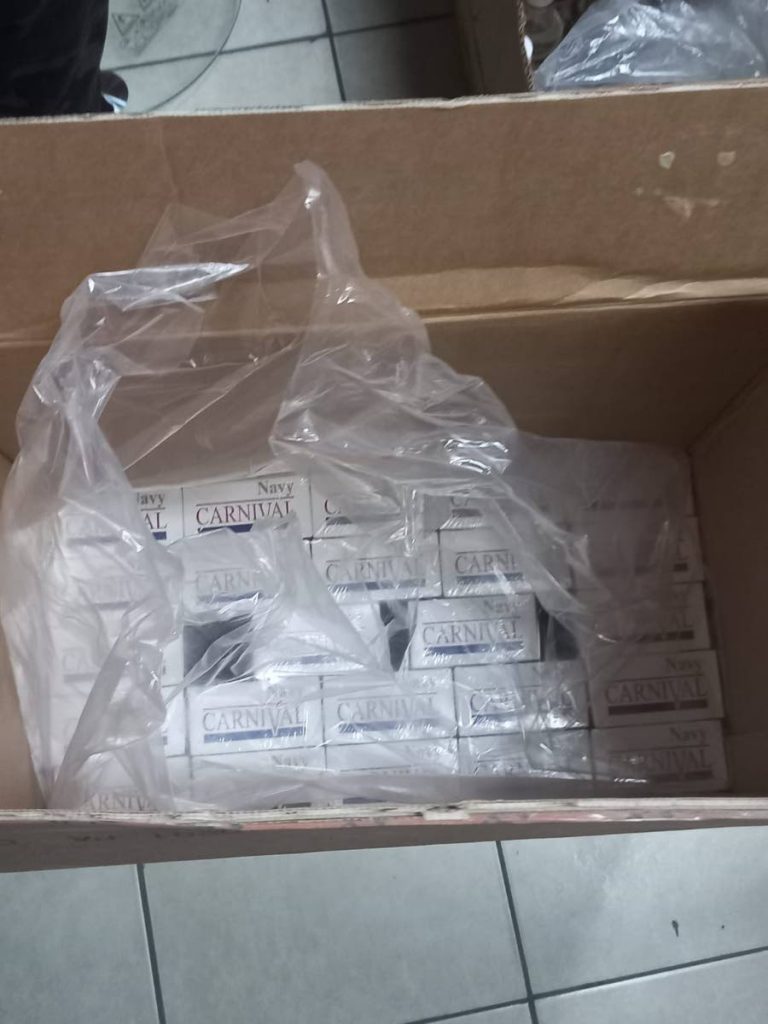A box containing a quantity of Navy Carnival cigarettes were found and seized by police and other officers during a search of a grocery in Tunapuna on Wednesday. 
The cigarettes along with other counterfeit or defective items were seizwd

PHOTO COURTESY TTPS - PHOTO COURTESY TTPS