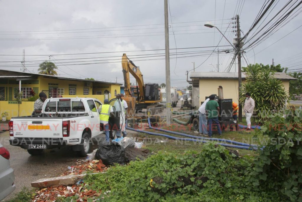 In this file photo, sewer water from the sinkhole on Main Street Beetham Gardens, is being pumped in a drain along the Priority Bus route by WASA. - Photo by Sureash Cholai