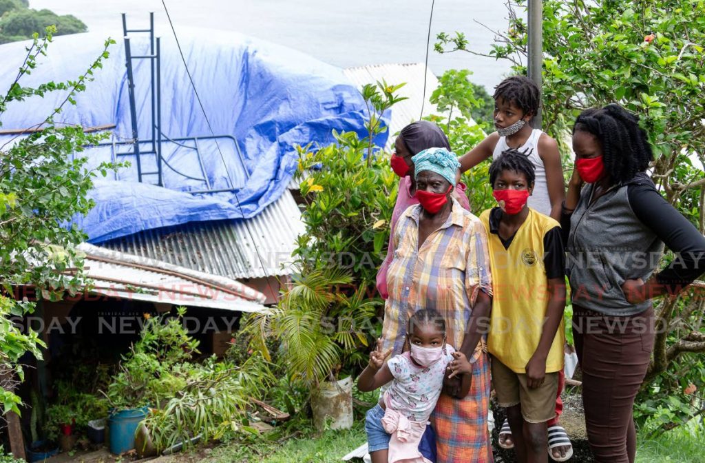 Pensioner Ruby Solomon, front, lost the roof of her Mt St George home after strong winds caused havoc throughout the country on Thursday night. - David Reid