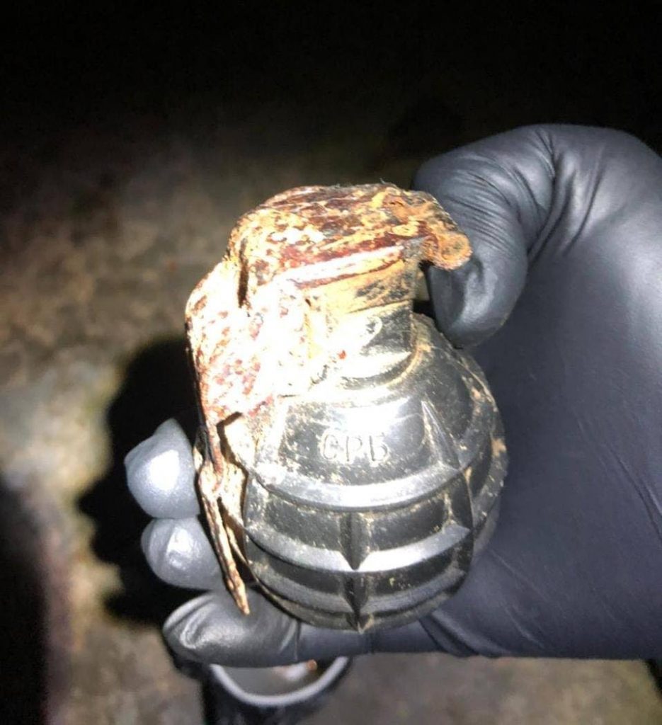 SEIZED: This grenade along with a quantity of ammunition was seized by police during a warrant search exercise in St Joseph on Sunday night. Two men were arrested. PHOTO COURTESY TTPS  - 