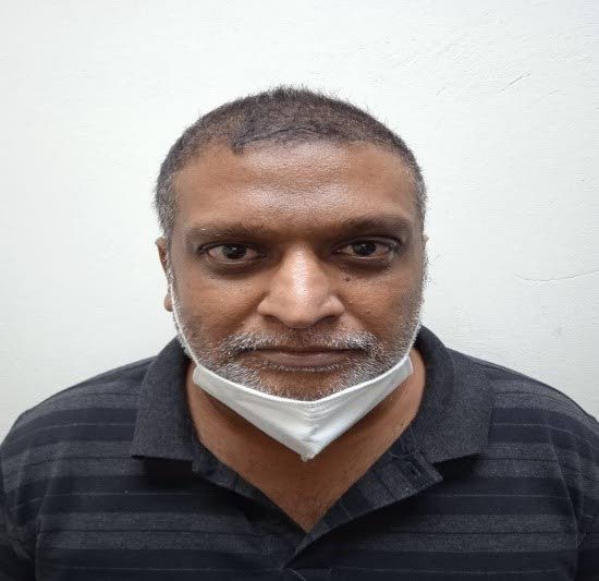 Rasheed Ali, 48, was arrested and charged for 12 counts of fraudulent conversion on Monday. 

PHOTO COURTESY TTPS 