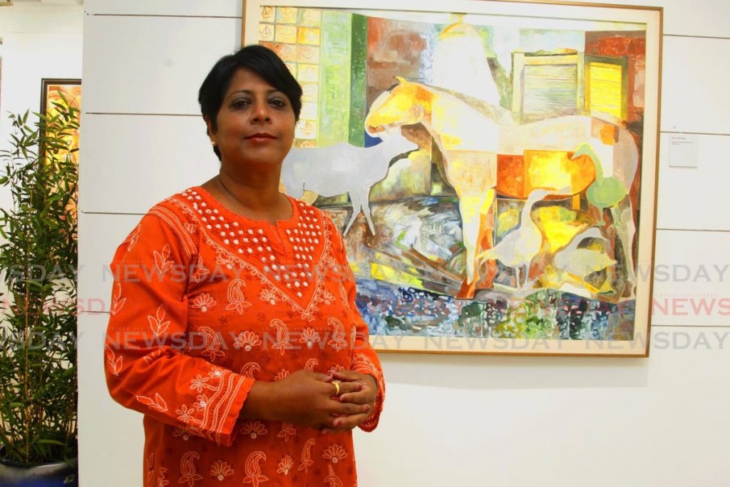 Sasmita Mishra Sahu gave up her position as an economics lecturer  to do art full-time. Alongside is one of her pieces Horse in the Shower in her exhibition The Moorings at Horizon Art Gallery, Mucurapo Road, St James.  - PHOTO BY ROGER JACOB