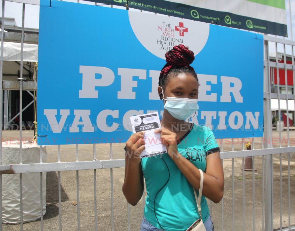 Adialla Aprel, USC student proudly displays her vaccination card after receiving her first dose of the Pfizer vaccine at the Paddock of the Queen's Park Savannah in Port of Spain on Wednesday.  Photos by Sureash Cholai